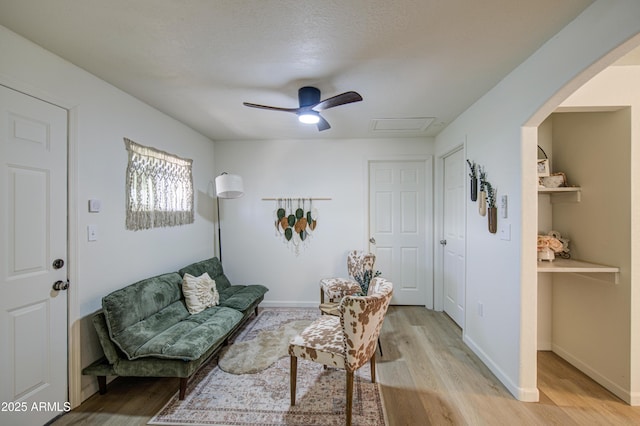 552 E 8th St, Florence, AZ 85132 - living room with arched walkways, ceiling fan, attic access, and light wood finished floors