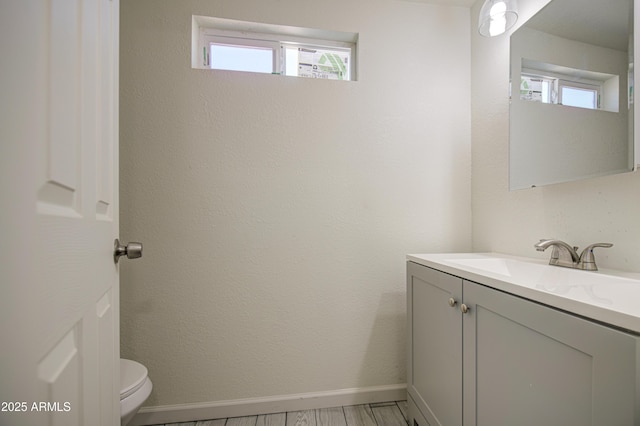 552 E 8th St, Florence, AZ 85132 - half bathroom featuring vanity, baseboards, and toilet