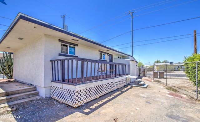 552 E 8th St, Florence, AZ 85132 - rear view of property with fence, stucco siding, and a deck