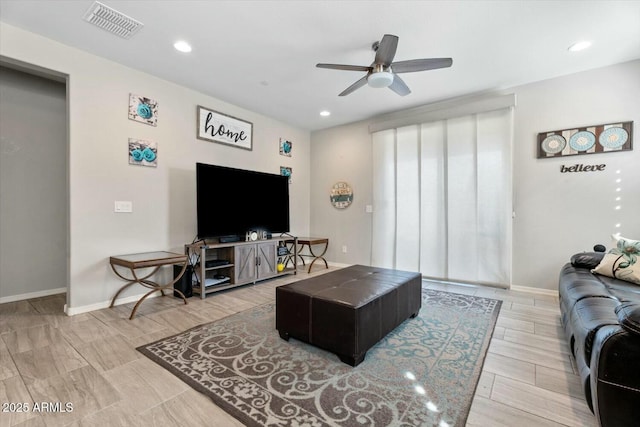 living room featuring baseboards, visible vents, ceiling fan, and recessed lighting