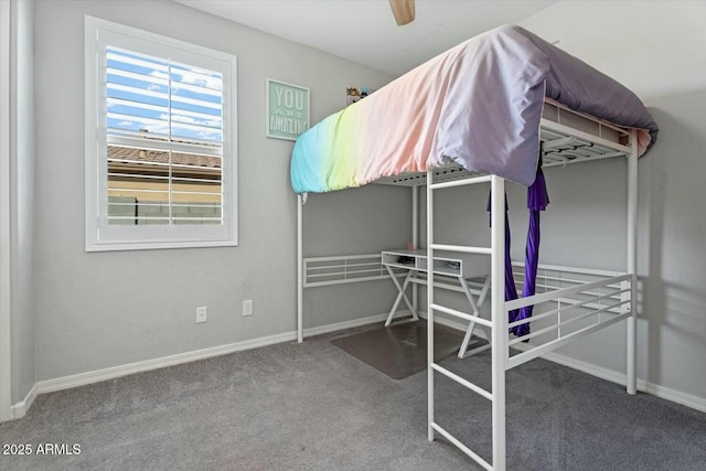 unfurnished bedroom with a ceiling fan, carpet, and baseboards