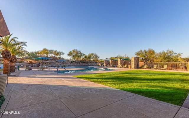 exterior space with a fenced in pool, a yard, a patio, and fence