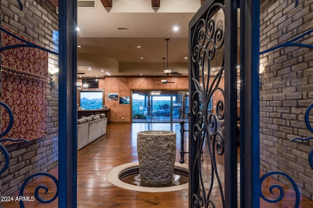 interior space featuring brick wall and dark wood-type flooring