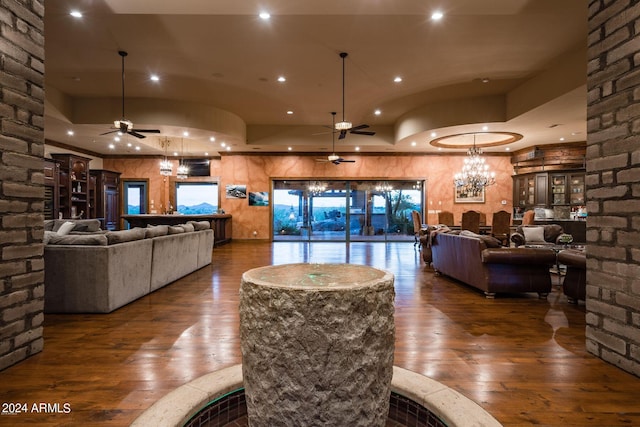 interior space featuring dark hardwood / wood-style flooring and ceiling fan with notable chandelier