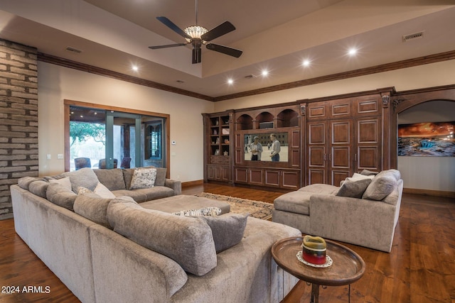 living room with brick wall, dark wood-type flooring, ornamental molding, and ceiling fan