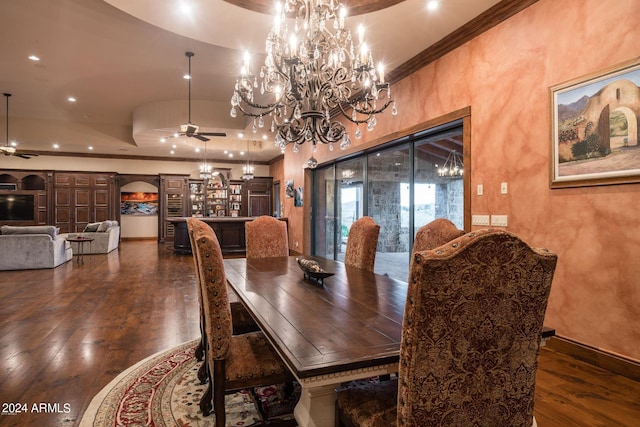 dining room with crown molding, dark hardwood / wood-style floors, and ceiling fan with notable chandelier