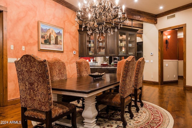 dining area with an inviting chandelier, crown molding, and dark wood-type flooring