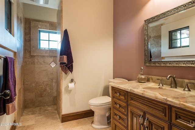 bathroom with toilet, tile floors, and large vanity