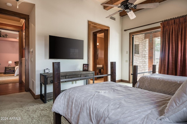 carpeted bedroom with beam ceiling and ceiling fan