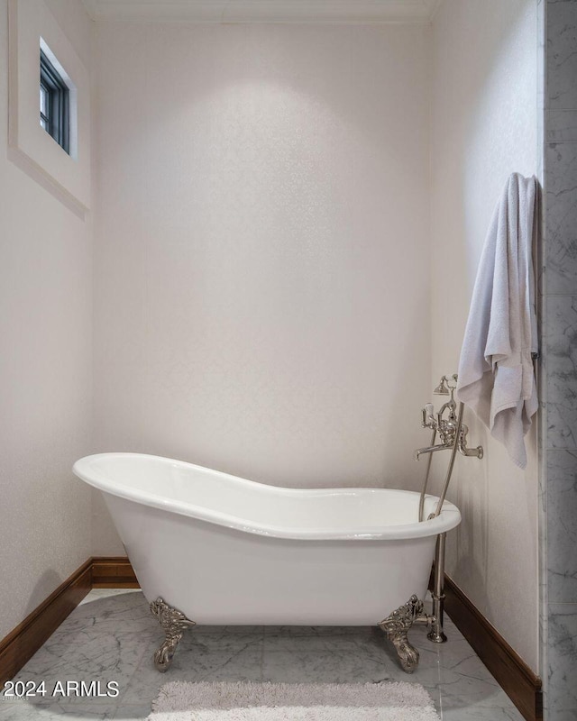 bathroom with a washtub and tile flooring