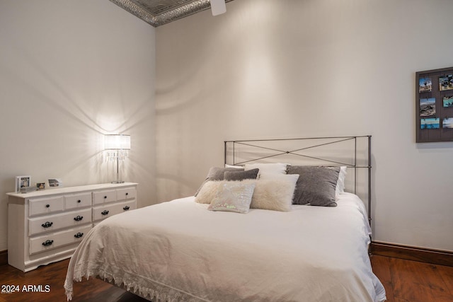 bedroom with dark wood-type flooring