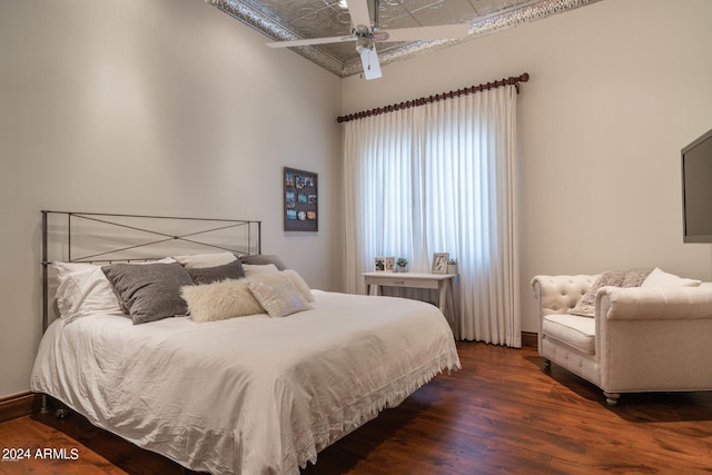 bedroom with vaulted ceiling, ceiling fan, and dark hardwood / wood-style floors