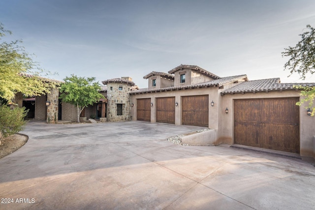 mediterranean / spanish home featuring a garage