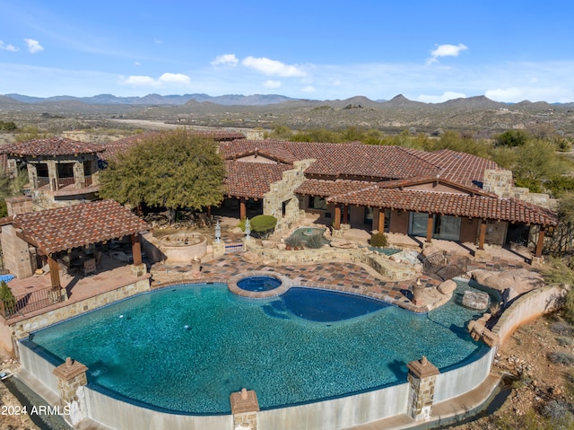 view of swimming pool with a gazebo, a patio area, and a mountain view