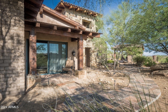 entrance to property featuring a patio