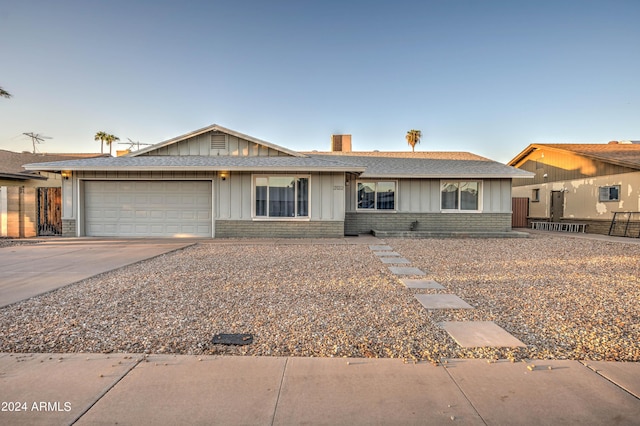 2122 E Radcliffe Dr, Tempe, AZ 85283 - ranch-style house featuring board and batten siding, an attached garage, concrete driveway, brick siding, and roof with shingles