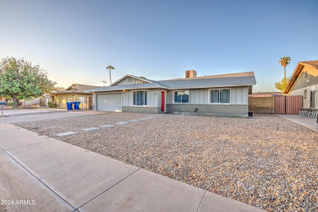 2122 E Radcliffe Dr, Tempe, AZ 85283 - ranch-style home with board and batten siding, brick siding, a garage, and driveway