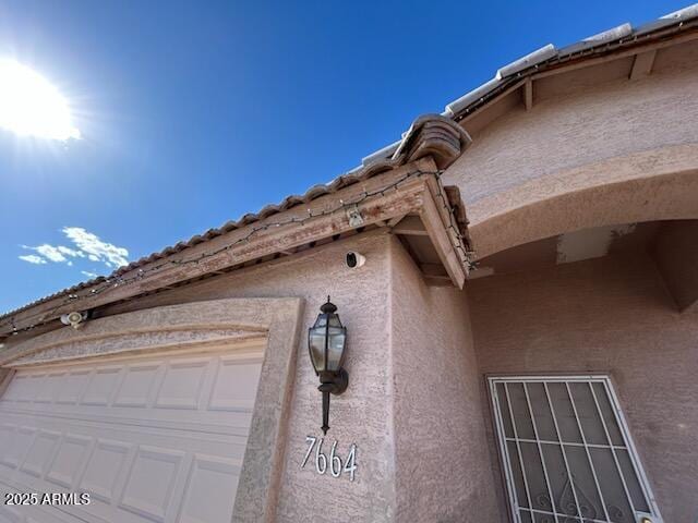 7664 W Vermont Ave, Glendale, AZ 85303 - exterior view of stucco siding, a surveillance system, and arched walkways