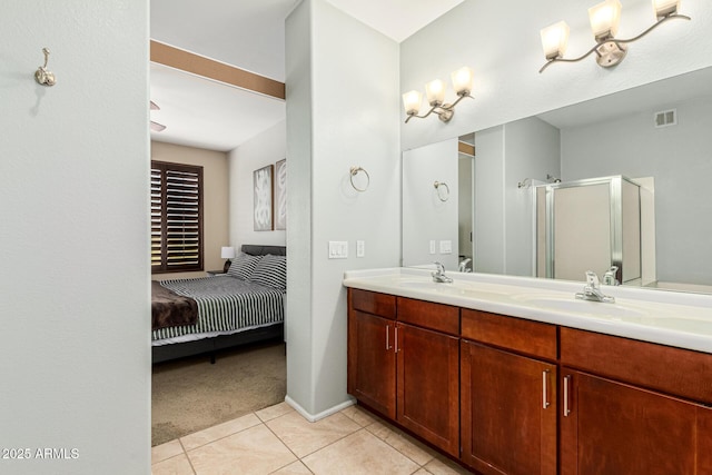 bathroom featuring tile patterned floors, an enclosed shower, and vanity