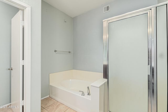 bathroom with shower with separate bathtub and tile patterned floors