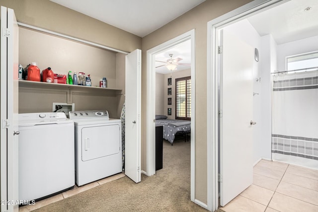 clothes washing area with washing machine and dryer and light colored carpet