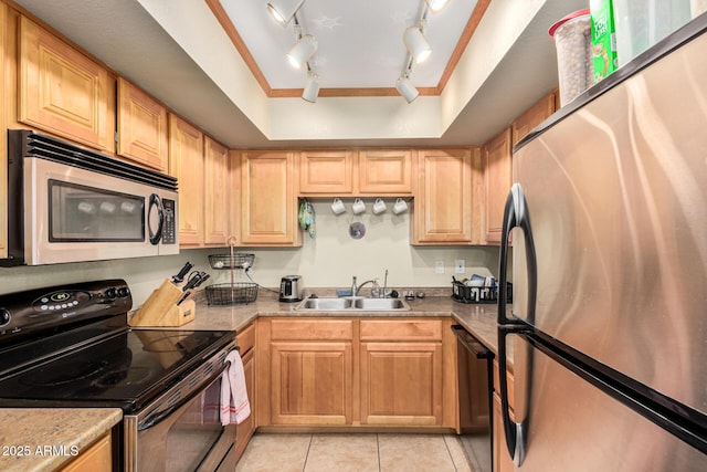 kitchen with sink, light tile patterned floors, stainless steel appliances, a tray ceiling, and light brown cabinets