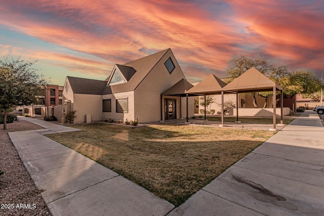 view of front of home with a lawn