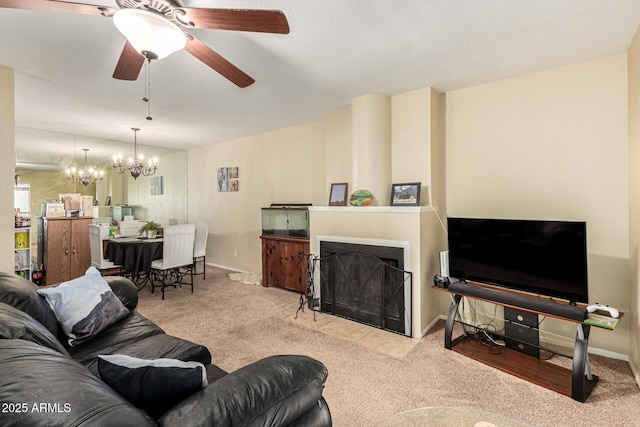 living room featuring ceiling fan with notable chandelier and light colored carpet