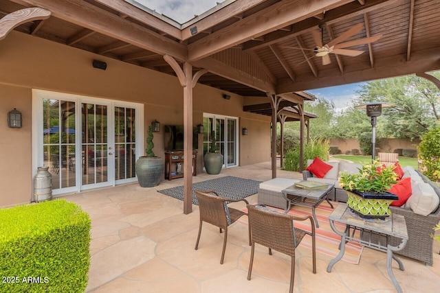 view of patio featuring ceiling fan, french doors, and an outdoor living space