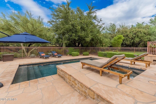 view of pool featuring a patio area, fence, and a fenced in pool