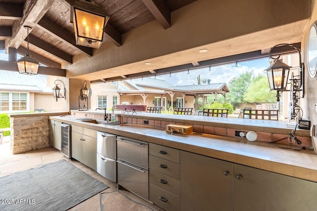 view of patio featuring exterior kitchen, beverage cooler, and a sink