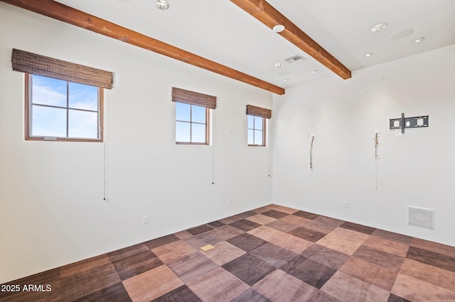 empty room featuring beamed ceiling, visible vents, and recessed lighting