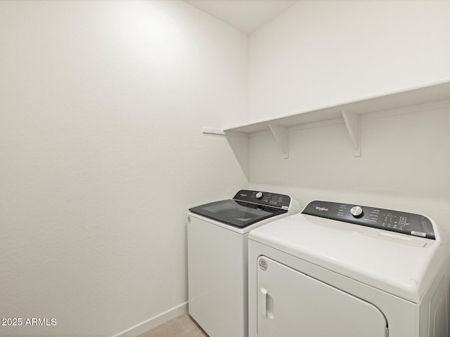 laundry room with laundry area, baseboards, and separate washer and dryer