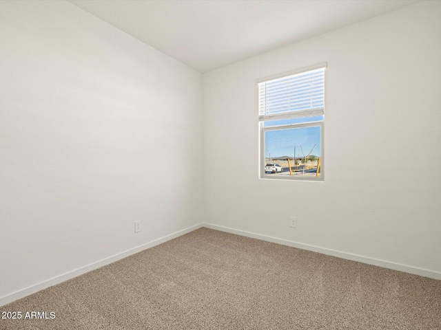 empty room with carpet flooring and baseboards