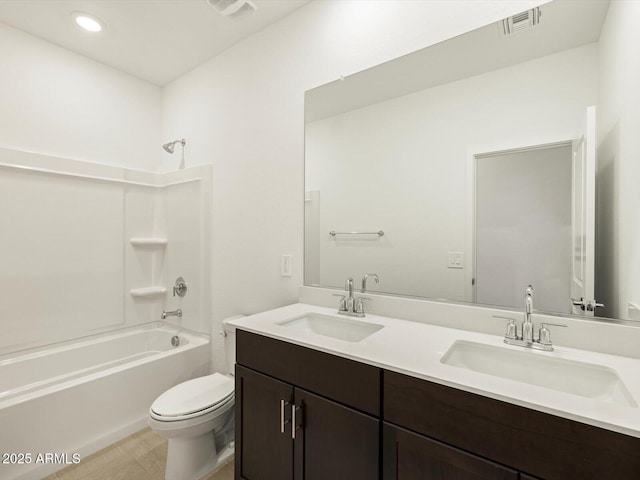 full bath featuring toilet, visible vents, a sink, and shower / bathtub combination