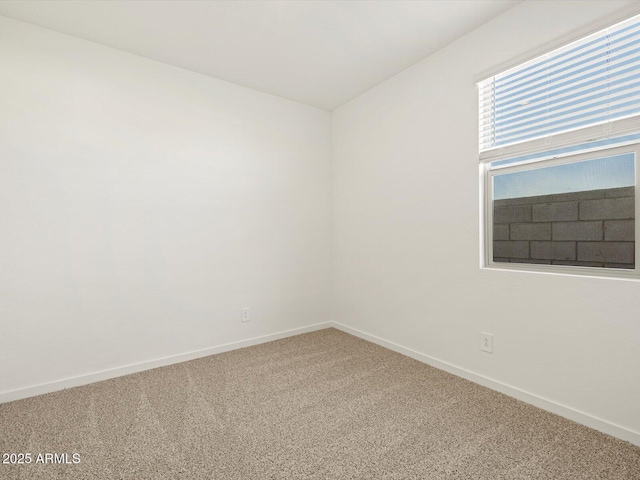 empty room featuring carpet floors and baseboards