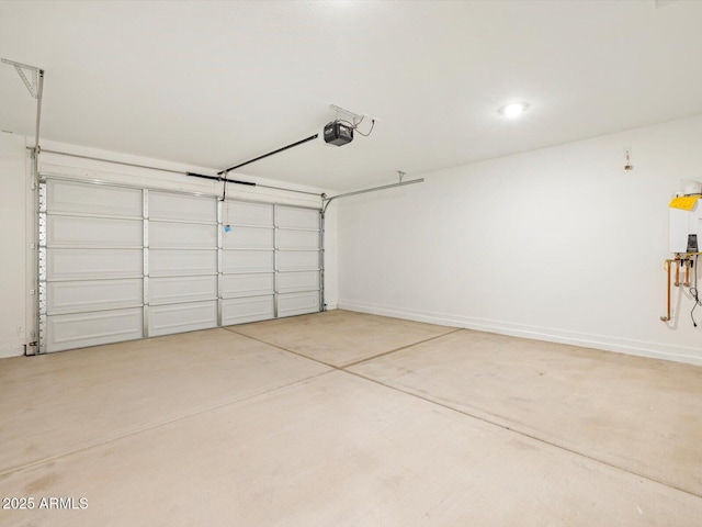 garage featuring a garage door opener and baseboards