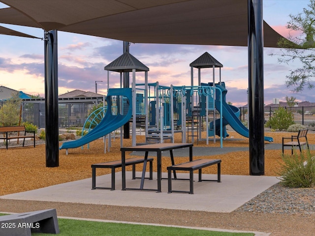 playground at dusk featuring playground community and fence