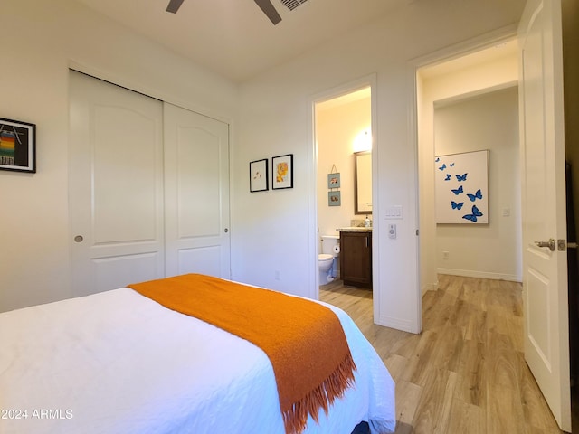 bedroom with connected bathroom, ceiling fan, a closet, and light hardwood / wood-style floors