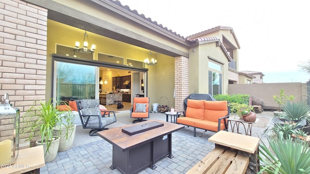 view of patio / terrace with an outdoor living space with a fire pit