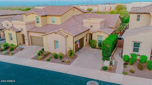 mediterranean / spanish-style house with a garage