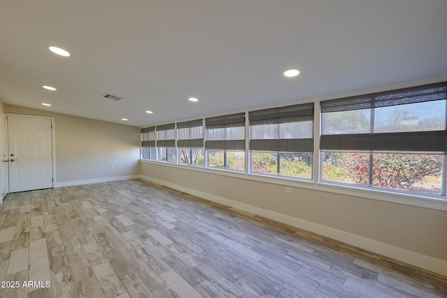 empty room with plenty of natural light and light wood-type flooring