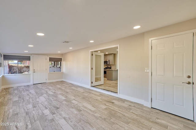 unfurnished living room with light wood-type flooring