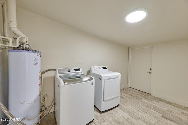 laundry area with gas water heater, light hardwood / wood-style floors, and independent washer and dryer