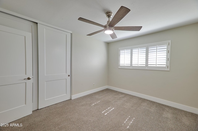 unfurnished bedroom with light carpet, a closet, and ceiling fan