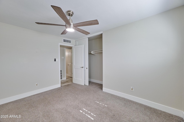 unfurnished bedroom with ceiling fan, light colored carpet, and a closet