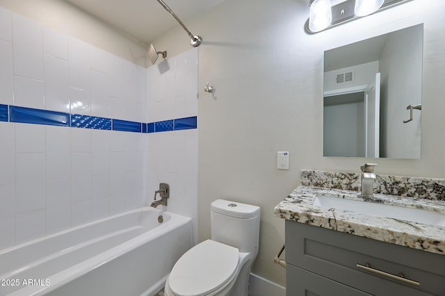 full bathroom featuring tiled shower / bath, vanity, and toilet