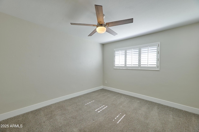 spare room featuring ceiling fan and carpet floors