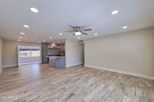 unfurnished living room with ceiling fan and light wood-type flooring