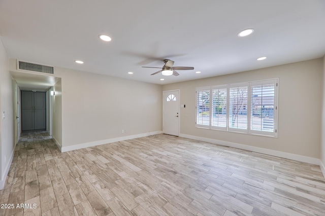 empty room featuring ceiling fan and light hardwood / wood-style floors